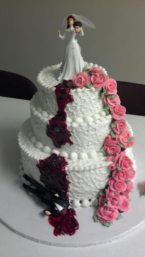 Bride holds grooms head with cascading pink roses tiered divorce cake | riotdaily.com