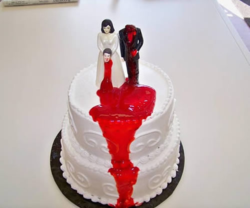 Bride in white holding her grooms head divorce cake | riotdaily.com